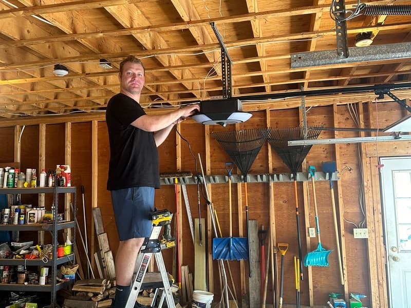 Murray's garage door technician servicing an opener in a Massachusetts garage